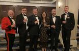 Group of people standing together at an awards ceremony