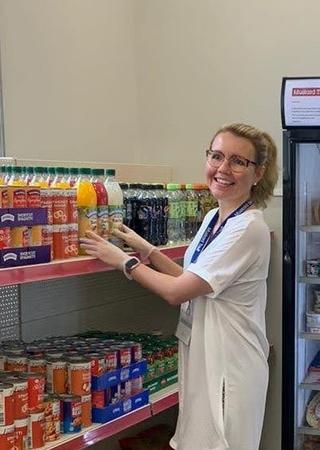 Individual helping to stack shelves