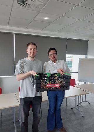 Two individuals with a food basket in an office space
